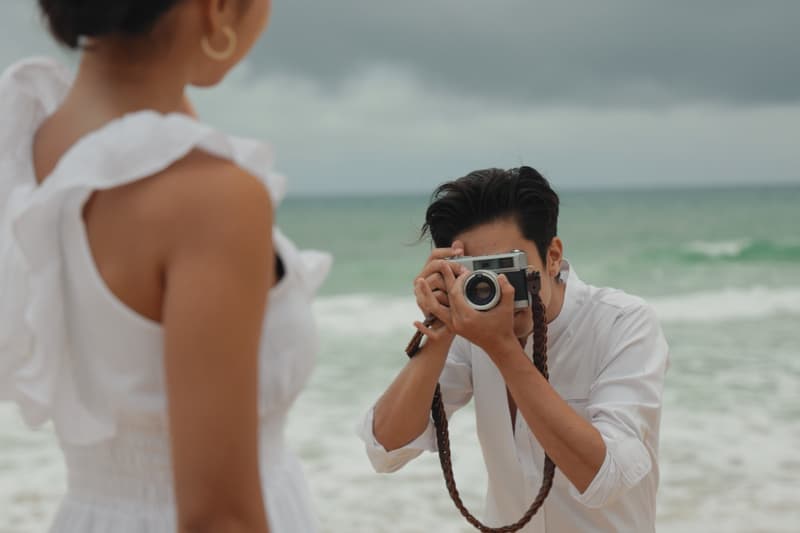 A photographer taking pictures on a beach