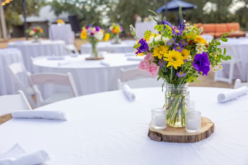 Tables set with flowers for an outdoor event