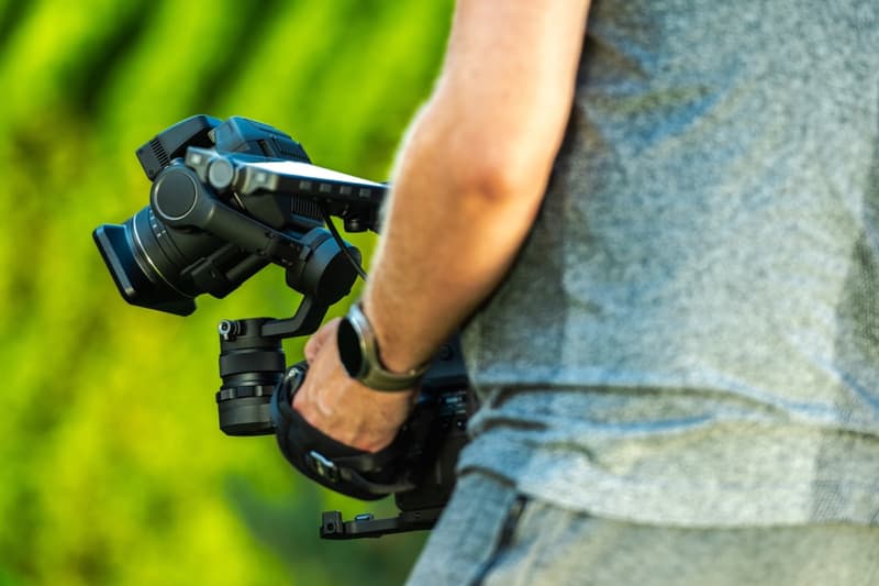 A videographer filming with a camera stabilizer
